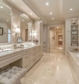 A luxurious bathroom with marble flooring, elegant lighting, and a spacious vanity.