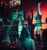karaoke: a group of people standing on a stage