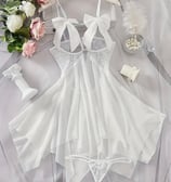 a white dress with a white dress and a bouquet of flowers