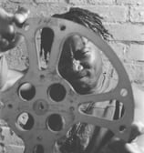 a man holding a film reel