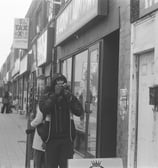 a man taking a picture of a woman on the phone