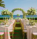 Luxury outdoor wedding setup featuring elegant acrylic chairs, floral centerpieces, and gold accents by Las Carolinas Events