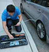 a man is fixing a toolbox in a car