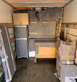 a moving truck with a bed and a bed in the back
