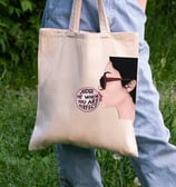 a person holding a bag with a picture of a woman's face