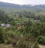 a view of a village in the mountains