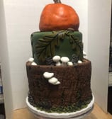 a cake with a pumpkin and a pumpkin on top of it