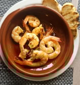 Crispy fried calamari served in a bowl as a delicious seafood starter, garnished with herbs