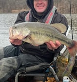 a man in a kayak holding a fish