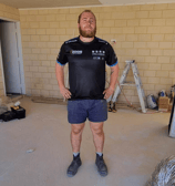 a man standing in a room with a ladder