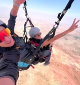 A happy passenger flying in Aguergour, enjoying the scenic view.