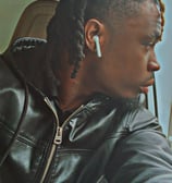 a man with dreadlocks and earphones on his head