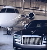 a car parked in a garage with a jet plane