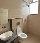 bathroom with a hot water shower, toilet.