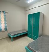 2 sharing room with Bed and furniture