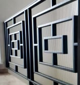 a wall mounted metal art deco paneled in a room