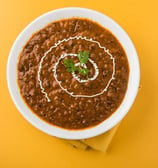 a bowl of dal makhani bukhari with cream