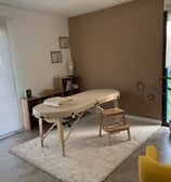a massage table with a massage table and chairs