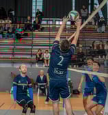 Joueur de Vélizy qui fait une passe en étant collé au filet