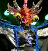 a man in a costume with a dragon headdress