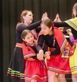 a group of young girls in colorful dresses and colorful clothes
