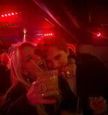 a couple is posing at the bar