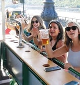 a group of women sitting at a Beer Bike Riga