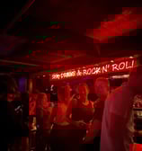 a group of people standing in a bar