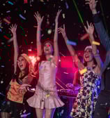 Group of young partygoers celebrating under confetti and lights during a high-energy DTLV nightlife experience.