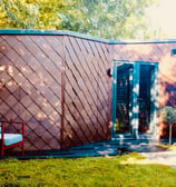 Ownmade bespoke garden studio with sloping roof, angled walls and architectural cladding