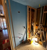 a bathroom with a ladder in it and tools