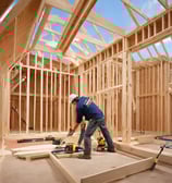 A tall green building with lots of windows