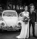 Black & White photo of a Bedfordshire bride and groom in front of the VW Beatle wedding car
