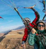 A banner featuring a pilot flying with a woman, both enjoying the flight.