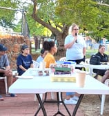 a group of people sitting at a table with drinks