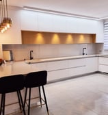 a kitchen with a table and chairs in the middle of the room