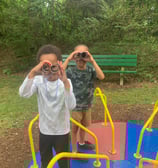 Children playing on the merry-go-round at Crescent Hills park