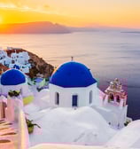 The famous blue dome churches in Greece, overlooking the sea in the beautiful Santorini travel