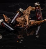 a bottle of liquid in a wooden sticker
