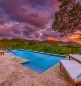 pool at sunset overlooking tropical garden and ocean at retreat center central america