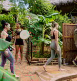 woman walking in Temazcal in tropical garden
