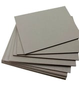 a stack of flat paper boards