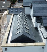 a construction worker is working on a roof