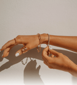 a woman's hands with rings and bracelets