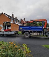 mini digger loaded on the back of a trailor in birmingham