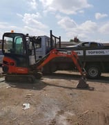 mini digger parked in front of a pickup truck in halesowen