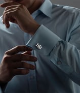 a man in a blue shirt and tie dye on his shirt