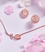 a pink rose gold jewelry set with a rose gold necklace and earrings