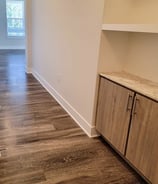 a kitchen with a wooden floor and a wooden cabinet