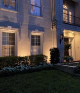 up lighting the front facade of a two story home